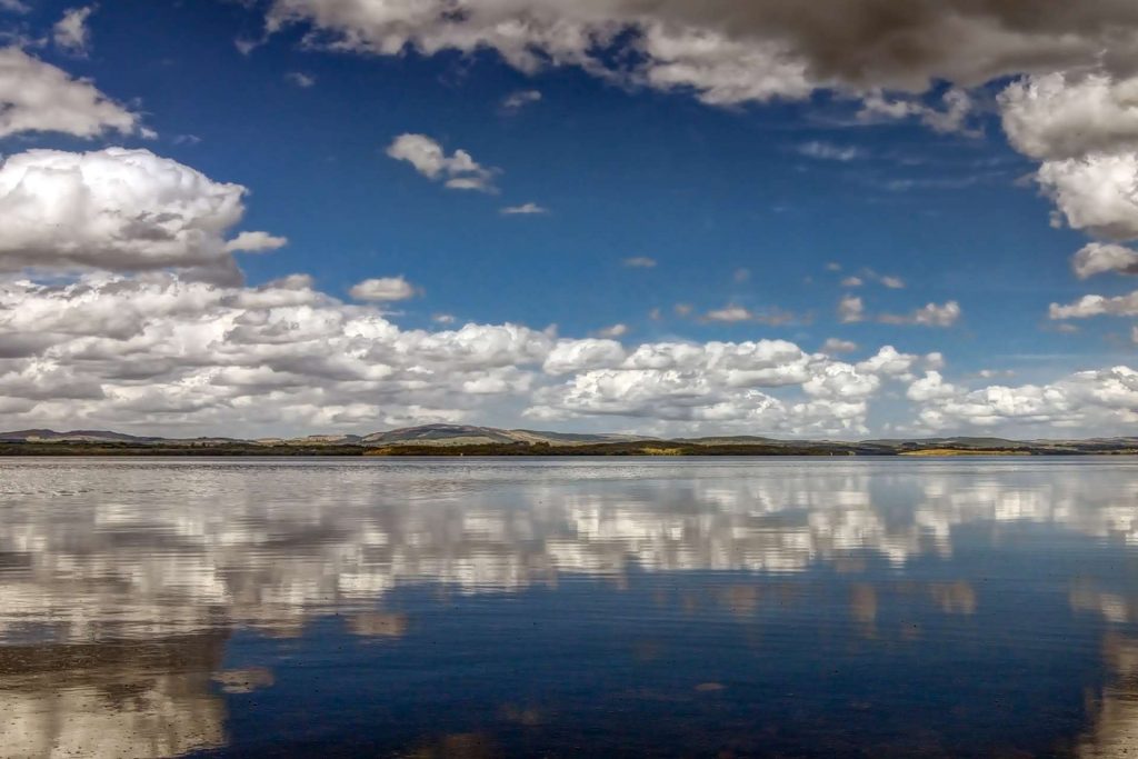 Kayaking Lower Lough Erne with blue skies and white clouds overhead